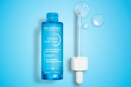 bottle of Hydrabio Hyalu+serum with eyedropper containing liquid